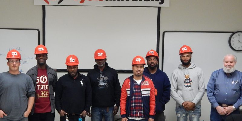 Men presented with red hard hats