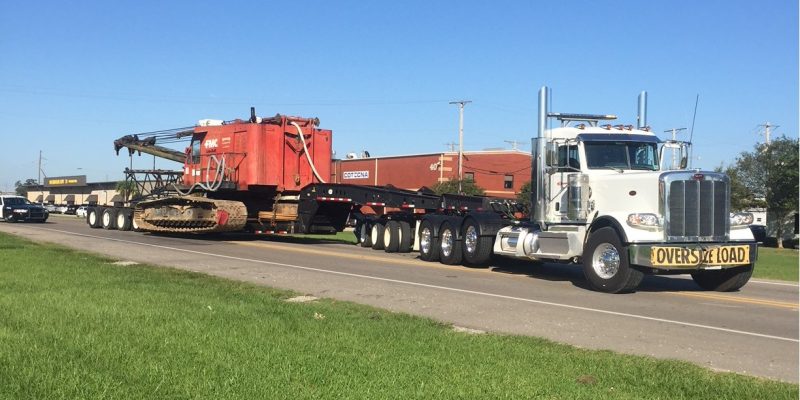 Truck moving heavy equipment